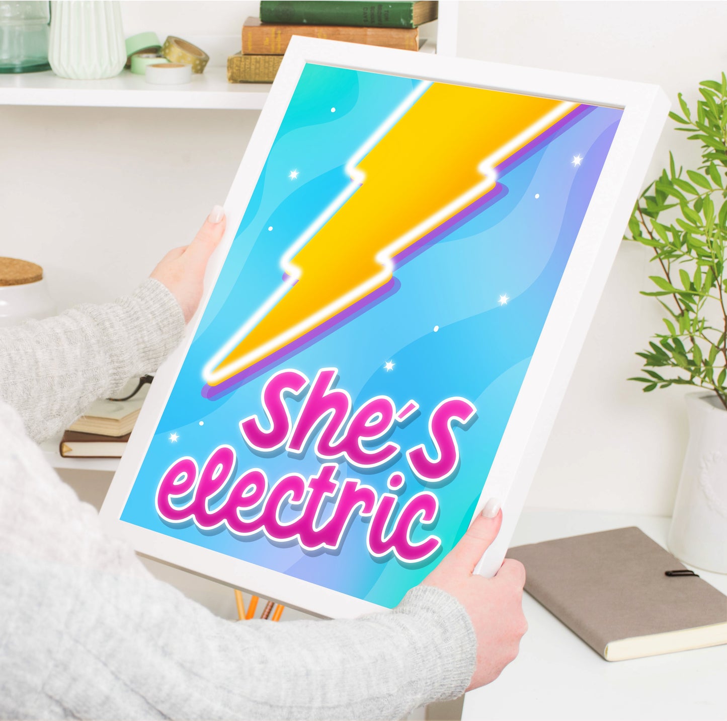 "Vibrant 'She's Electric' Wall Art Print with a bold lightning bolt illustration and bright pink quote, inspired by Oasis song."