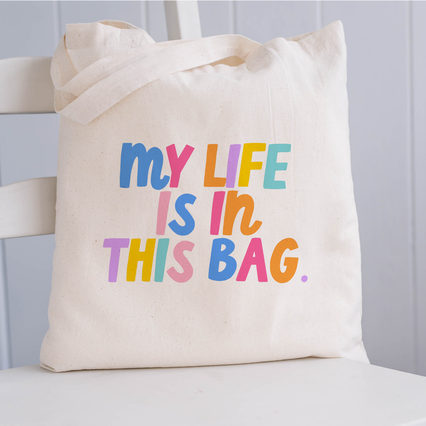 Bright Tote bag including the phrase 'my life is in this bag' in colorful block lettering