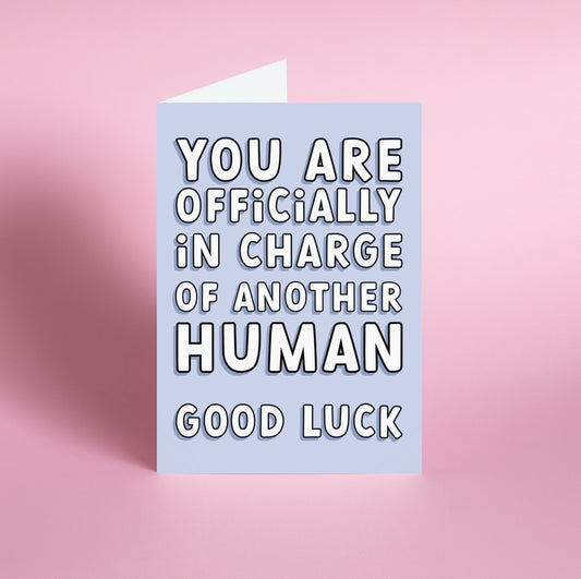 'Officially In Charge' New Baby Card Front: An energetic image showcasing the quote "You Are Officially In Charge of Another Human. Good Luck." Designed by Colourful Life, 5x7 inch size, with a smooth silk finish.