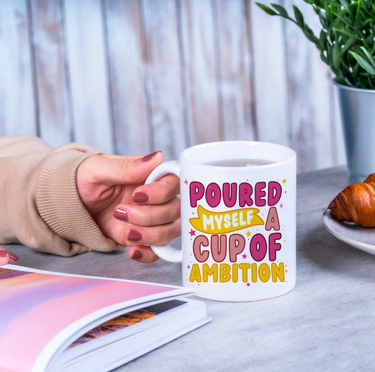 "White mug with 'Poured Myself a Cup of Ambition' quote, inspired by Dolly Parton's song. Glossy finish, UV resistant, 10oz size."