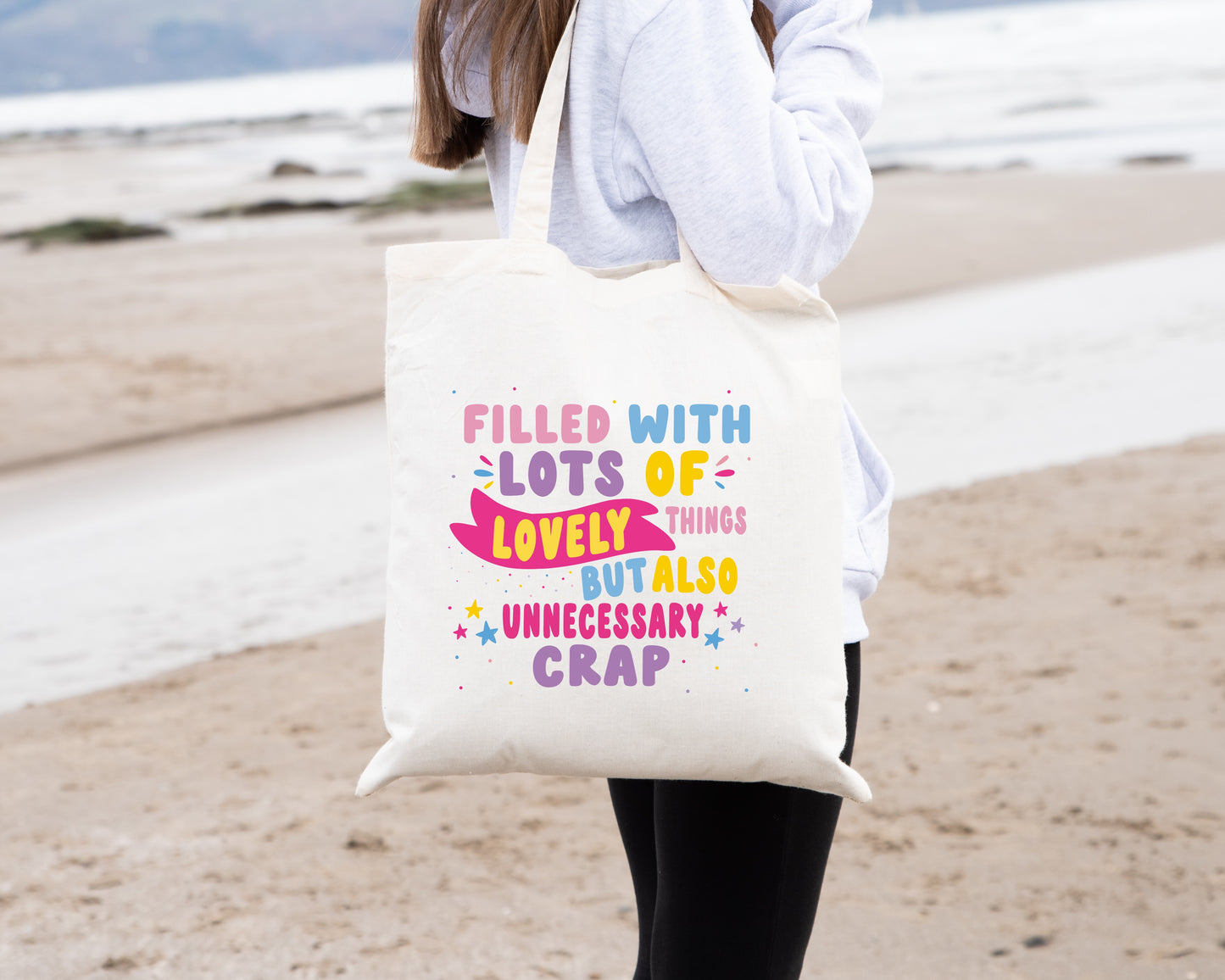 Colourful Tote Bag, with the quote "Filled with Lots of Lovely Things but Also Unnecessary Crap" in pink, purple, blue and yellow writing