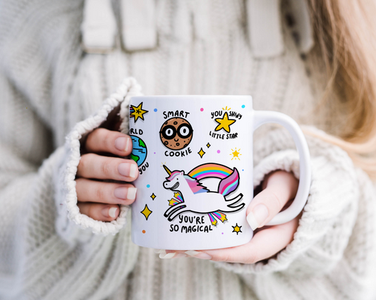 "Positivity Mug in Hand - A person holding a white mug with vibrant illustrations and quotes, radiating positivity."