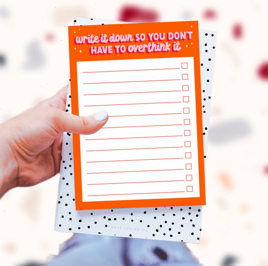 "Don't Overthink It" Notepad: A vibrant product image featuring the quote "write a list, so you don't have to overthink it." Designed by Colourful Life, A5 size, tear-off sheets, and a sturdy cardboard backing for organized simplicity.