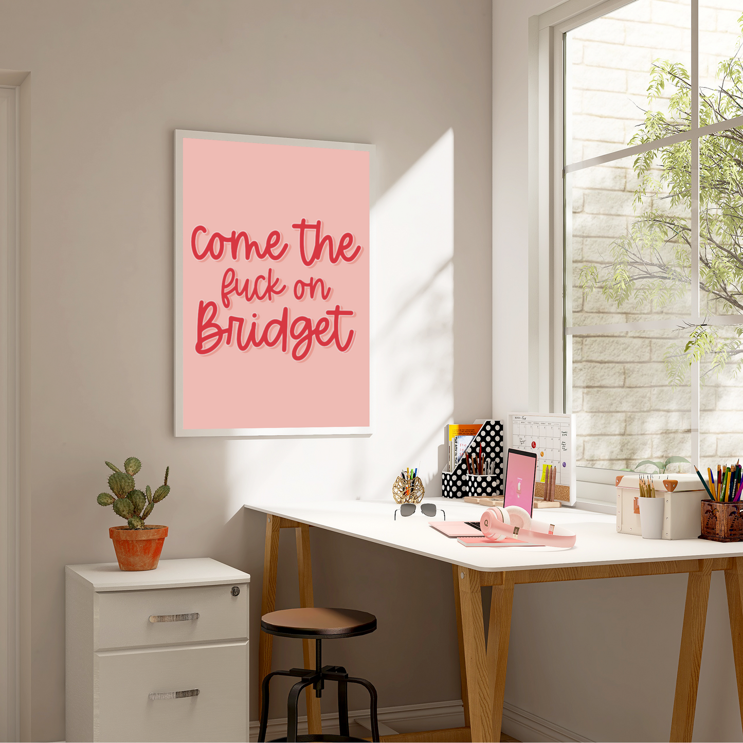 Colourful Print with the quote 'come the fuck on Bridget' from the movie Bridget Jones. Cursive bright pink font on a lighter pink background
