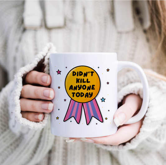"Cheerful mug holder showcasing the 'Didn't Kill Anyone Today' message with a medal illustration."