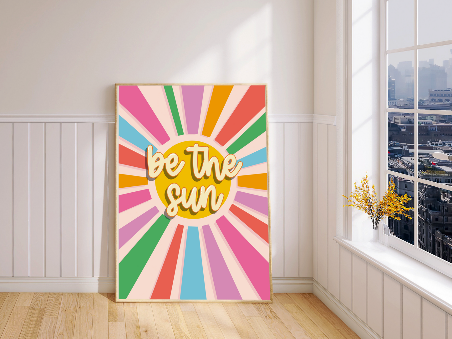 "Colorful Wall Decor - 'Be the Sun' Print in a sleek black frame. A reminder to radiate positivity, suitable for A5 to A3 spaces. Free UK delivery included."
