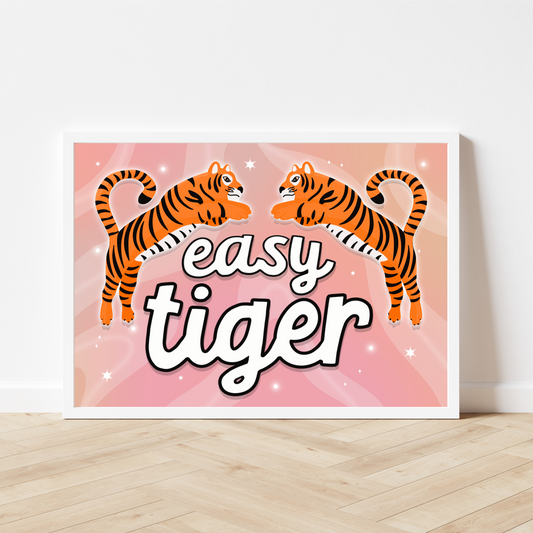  Framed 'Easy Tiger' Print: A vibrant print with a pink background featuring two illustrated tigers, adding a playful touch to any space.