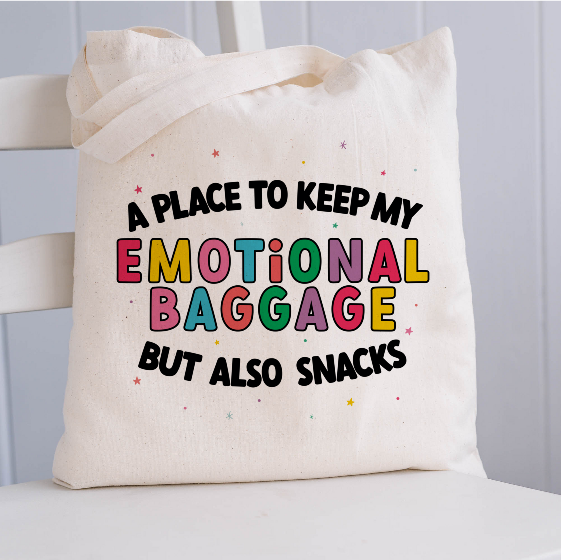 Natural coloured tote bag with the phrase 'a place to keep my emotional baggage but also snacks'