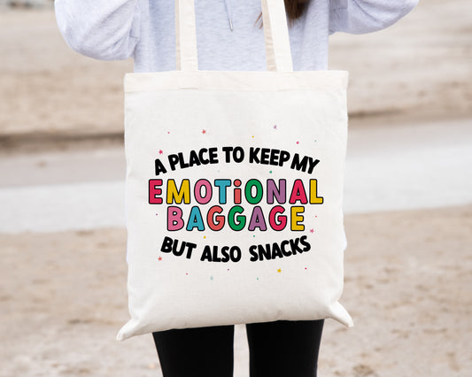 Natural coloured tote bag with the phrase 'a place to keep my emotional baggage but also snacks'