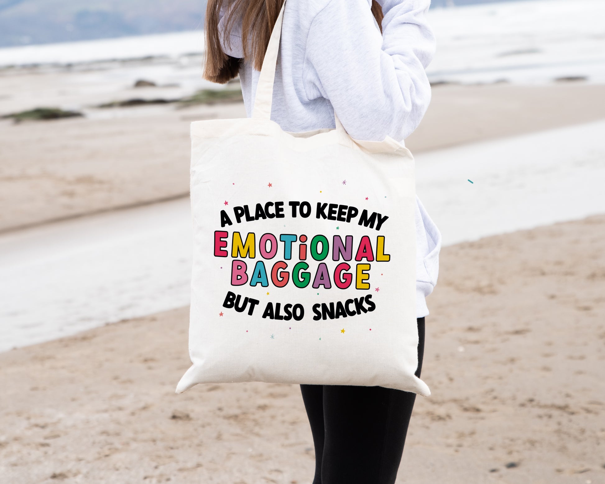 Natural coloured tote bag with the phrase 'a place to keep my emotional baggage but also snacks'